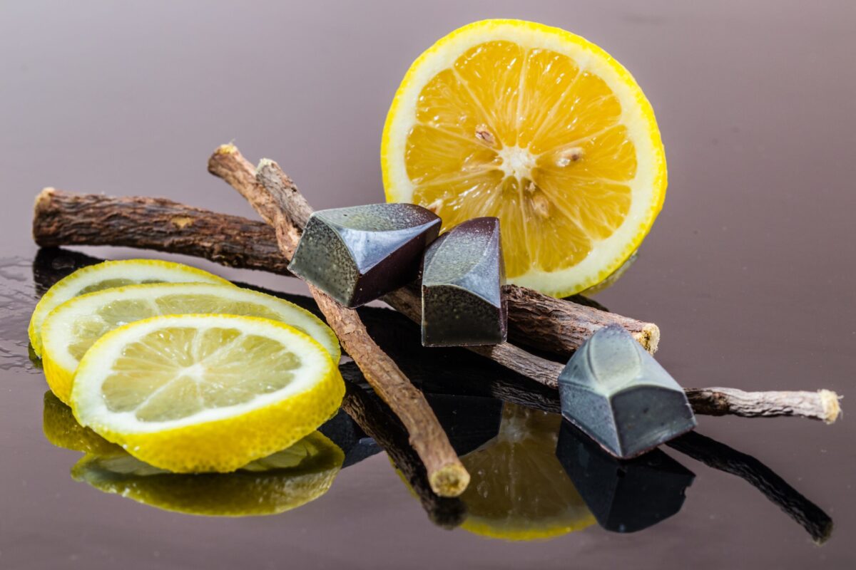 Liquorice, lemon slices and twigs on a dark background