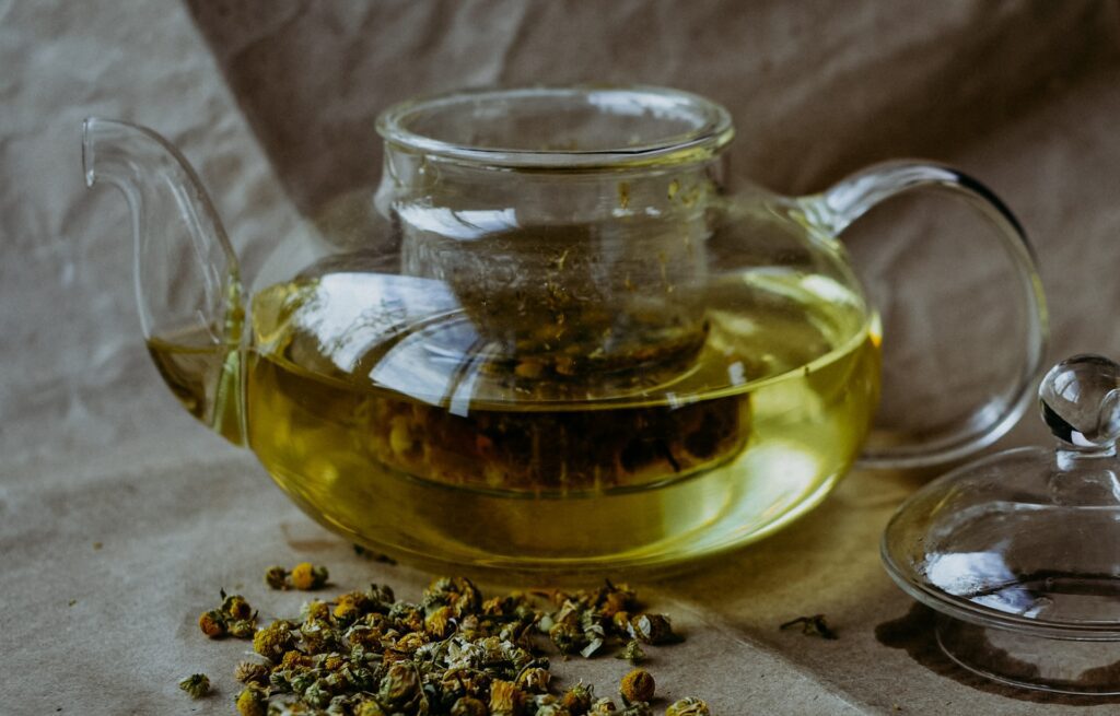 A glass pot of chamomile tea