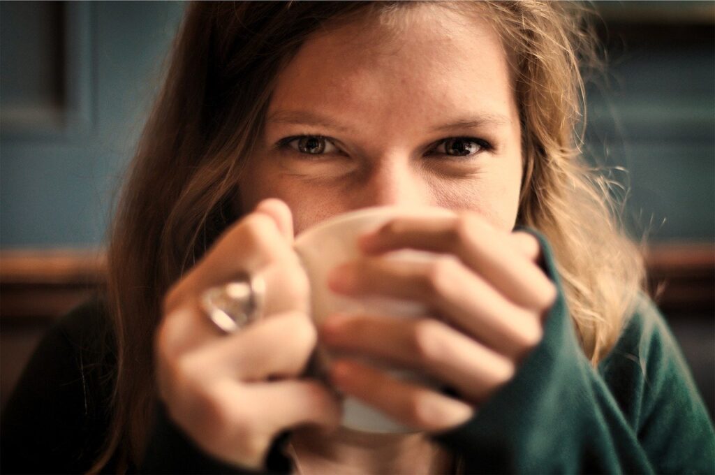 Woman drinking tea to balance hormones