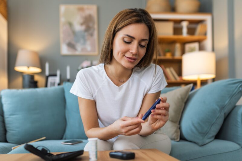 A woman tests her blood sugar levels