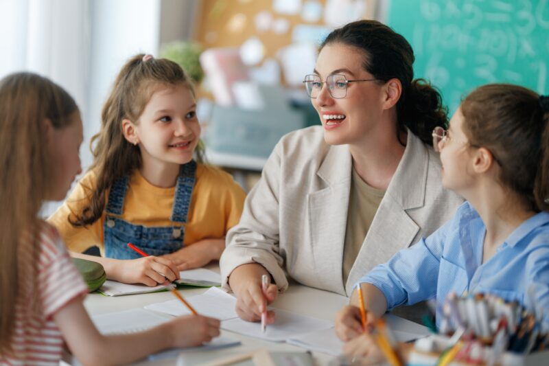 A teacher surrounded by students