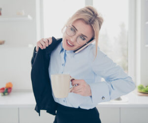 A busy professional woman drinks a cup of herbal tea.