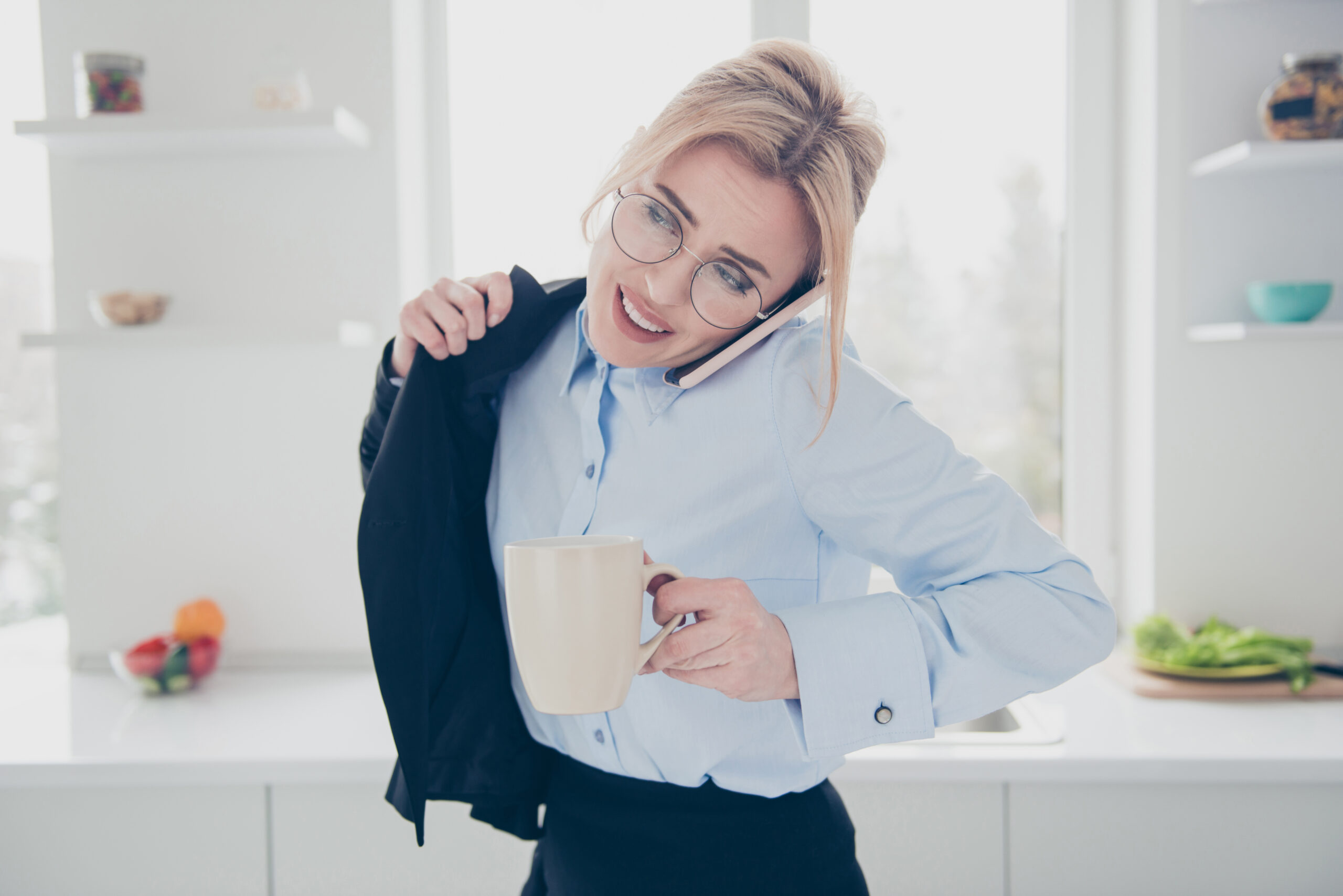 A busy professional woman drinks a cup of herbal tea.