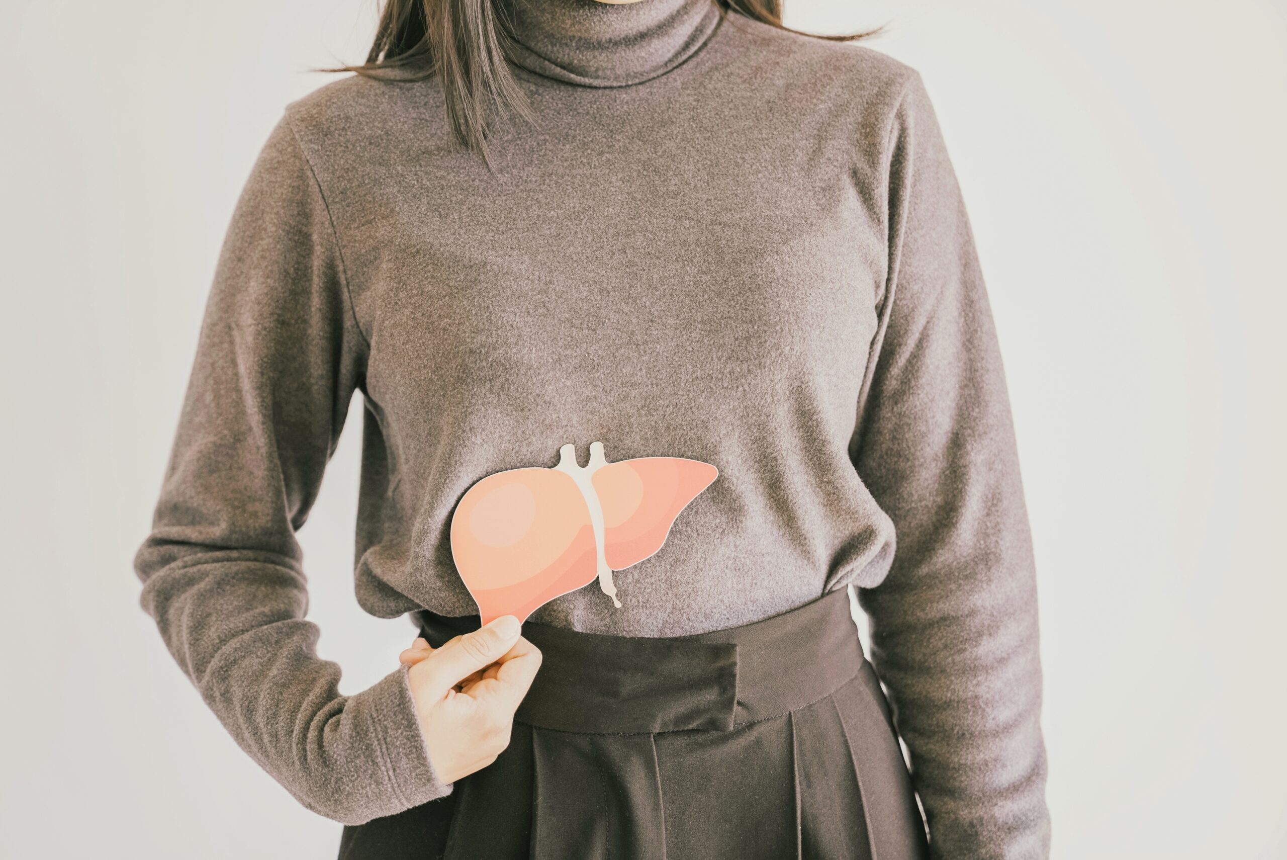 A person pointing to their liver to highlight health in January