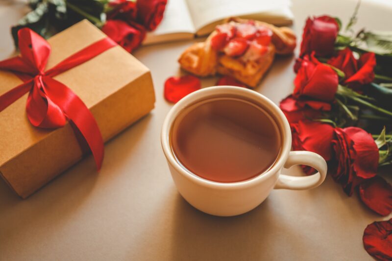 A mug of tea surrounded by valentines day gifts