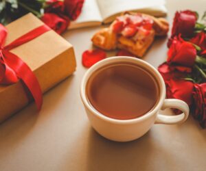 A mug of tea surrounded by valentines day gifts